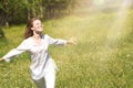 Happy Young Woman Enjoying Summer on the Green Meadow. Royalty Free Stock Photo