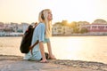 Happy young woman enjoying summer sunset vacation by the sea Royalty Free Stock Photo