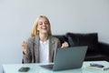 Happy young woman excited with great news, win, success, luck. Woman looking at laptop screen making winner gesture, shouting fir Royalty Free Stock Photo