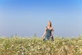 The happy young woman in the field of camomiles Royalty Free Stock Photo