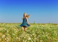 The happy young woman in the field of camomiles Royalty Free Stock Photo