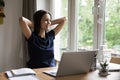 Satisfied woman finish work on laptop smile staring out window Royalty Free Stock Photo