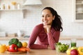 Happy Young Woman In Fitwear Posing At Table In Kitchen Royalty Free Stock Photo