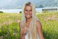 Happy young woman on a flower meadow