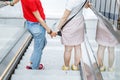 young woman friends on escalator in shopping mall Royalty Free Stock Photo