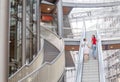 Young woman friends on escalator in shopping mall Royalty Free Stock Photo