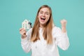 Happy young woman girl in casual white hoodie posing isolated on blue turquoise background studio portrait. People Royalty Free Stock Photo