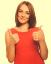 Happy young woman girl shows positive sign thumbs yes, orange dr Royalty Free Stock Photo