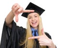 Happy woman in graduation gown framing with hands