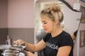 A happy young woman hairdresser at work. Process of hair coloring in modern salon. Barber services. Professional Royalty Free Stock Photo