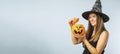 Happy young woman in halloween witch costume with pumpkin basket jack-o-lantern Royalty Free Stock Photo