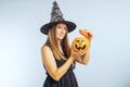 Happy young woman in halloween witch costume with pumpkin basket jack-o-lantern Royalty Free Stock Photo