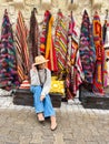 Old traditional Turkish carpet shop in cave house Cappadocia, Turkey Kapadokya. Young woman on vacation in Turkey Royalty Free Stock Photo