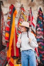 Old traditional Turkish carpet shop in cave house Cappadocia, Turkey Kapadokya. Young woman on vacation in Turkey Royalty Free Stock Photo