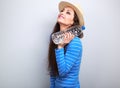 Happy young woman in hat holding bottle of water in hand and loo Royalty Free Stock Photo