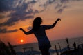 Happy young woman having fun with open hands at the sunset on sea. Royalty Free Stock Photo