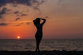 Happy young woman having fun with open hands at the sunset on sea. Royalty Free Stock Photo