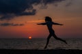 Happy young woman having fun with open hands at the sunset on sea. Royalty Free Stock Photo