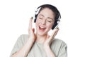Happy young woman with headphones singing along to music
