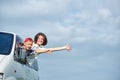 Happy young woman and her child looking out from windows. Family travelling by car Royalty Free Stock Photo