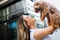 Happy woman with her dog smiling and palying outdoor