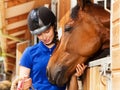 Happy young woman with her lovely bay horse Royalty Free Stock Photo