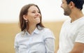 Happy young woman with her man walking together in summer field Royalty Free Stock Photo