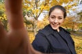 Happy young woman taking selfie photo in park with autumn colors Royalty Free Stock Photo