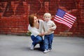 Happy young woman with her toddler son holding american flag Royalty Free Stock Photo