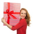 Happy young woman hold red Christmas wrapped gift present smiling Royalty Free Stock Photo