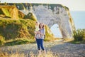 Happy young woman holding adorable toddler girl near famouse cliffs in Etretat Royalty Free Stock Photo