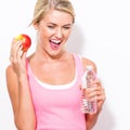 Happy young woman holding apple and water Royalty Free Stock Photo