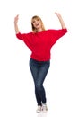 Happy Young Woman Is Holding Arms Raised, Dancing And Singing Royalty Free Stock Photo