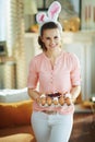 Happy young woman holding big egg carton box with food coloring Royalty Free Stock Photo