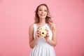 Happy young woman holding camera.