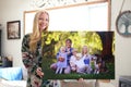 Happy Young Woman Holding Canvas Print of Family Portrait