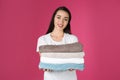 Happy young woman holding clean towels. Laundry day Royalty Free Stock Photo