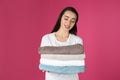 Happy young woman holding clean towels on color background Royalty Free Stock Photo