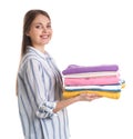 Happy young woman holding clean towels on white background Royalty Free Stock Photo