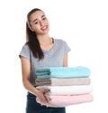 Happy young woman holding clean towels on white background Royalty Free Stock Photo