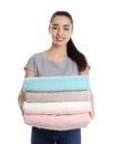 Happy young woman holding clean towels on white Royalty Free Stock Photo