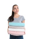 Happy young woman holding clean towels on white. Laundry day Royalty Free Stock Photo