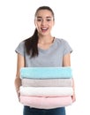 Happy young woman holding clean towels on white. Laundry day Royalty Free Stock Photo