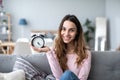 Happy young woman holding clock Royalty Free Stock Photo