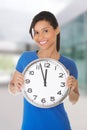 Happy young woman holding clock Royalty Free Stock Photo