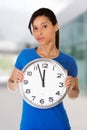 Happy young woman holding clock Royalty Free Stock Photo