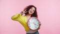happy young woman holding clock and Royalty Free Stock Photo