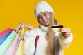 Happy young woman holding credit card, holding shopping bags Royalty Free Stock Photo