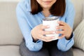 Dreaming girl sitting in living room with cup of hot coffee enjoying the rest Royalty Free Stock Photo