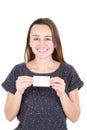 Happy young woman holding empty blank paper credit card and showing